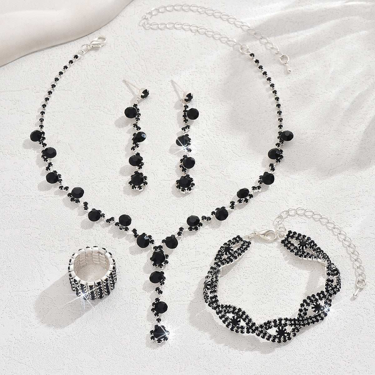 Braided bracelet and rhinestone ring set of four